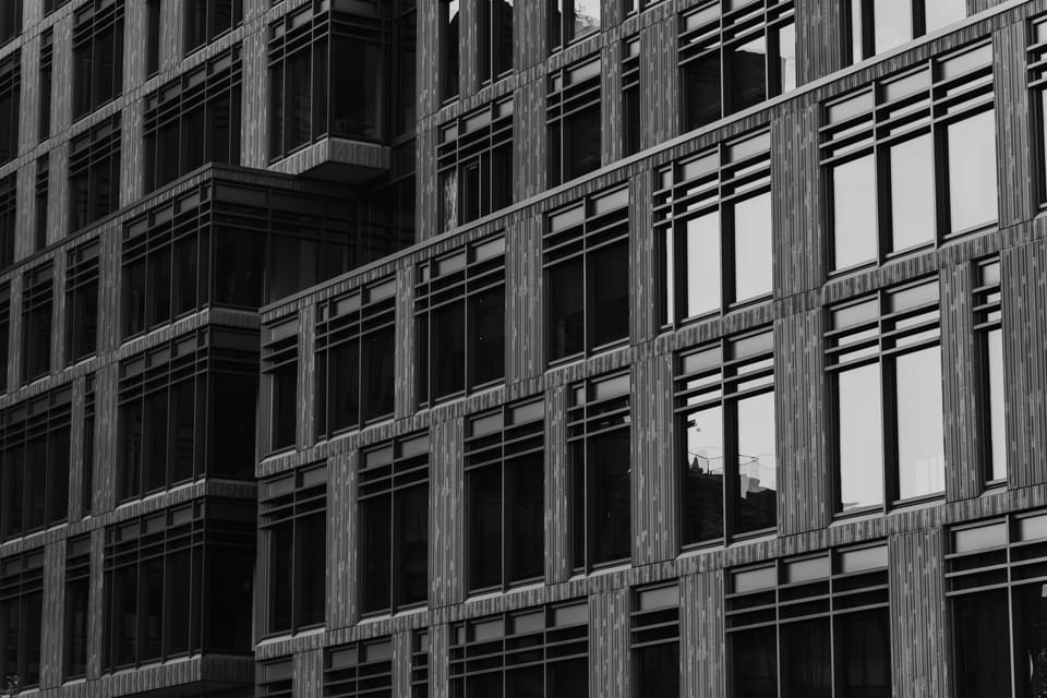 Black-and-white abstract of a building's repeating window grid