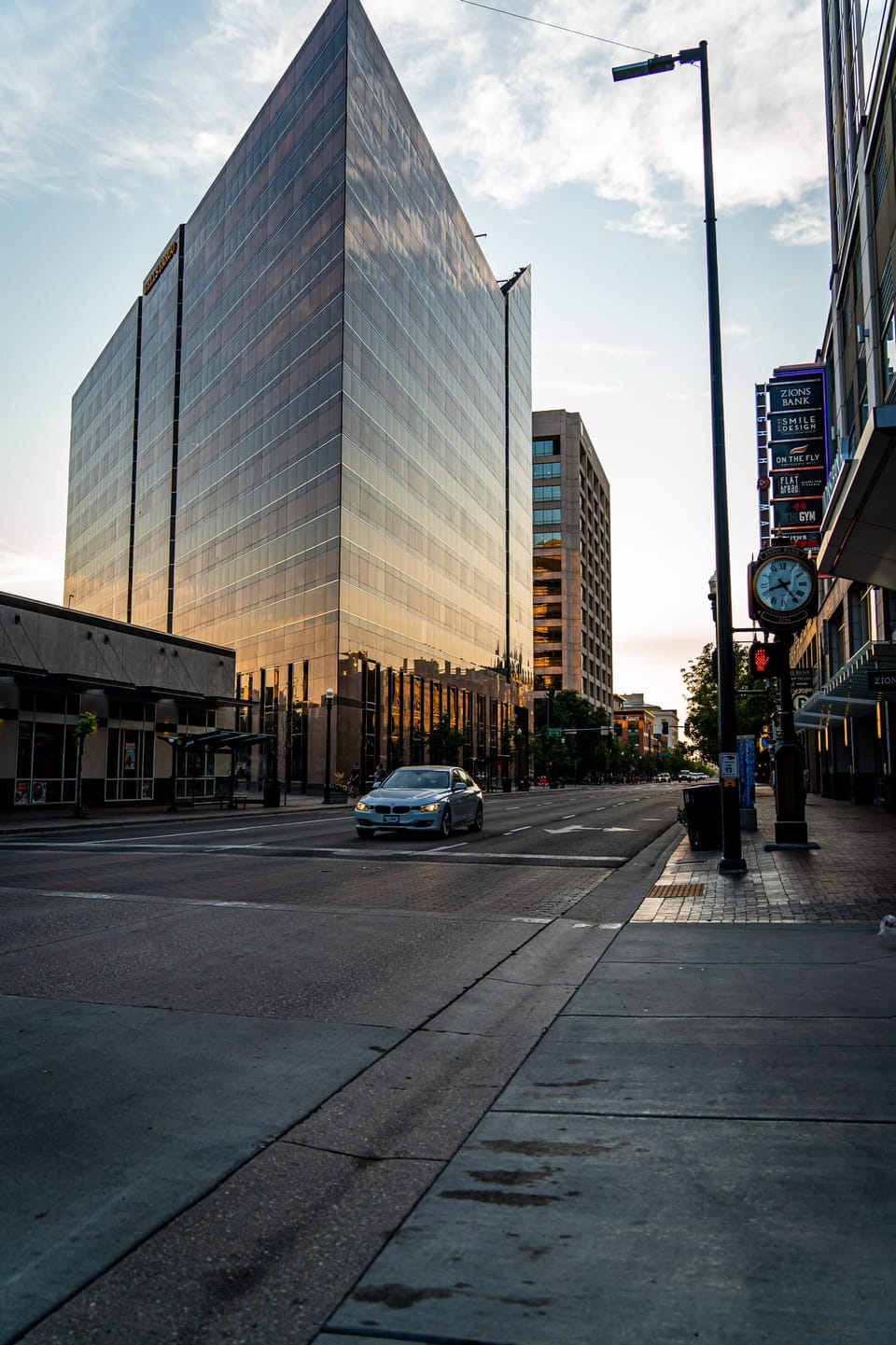 Mirrored glass office tower on a quiet downtown street