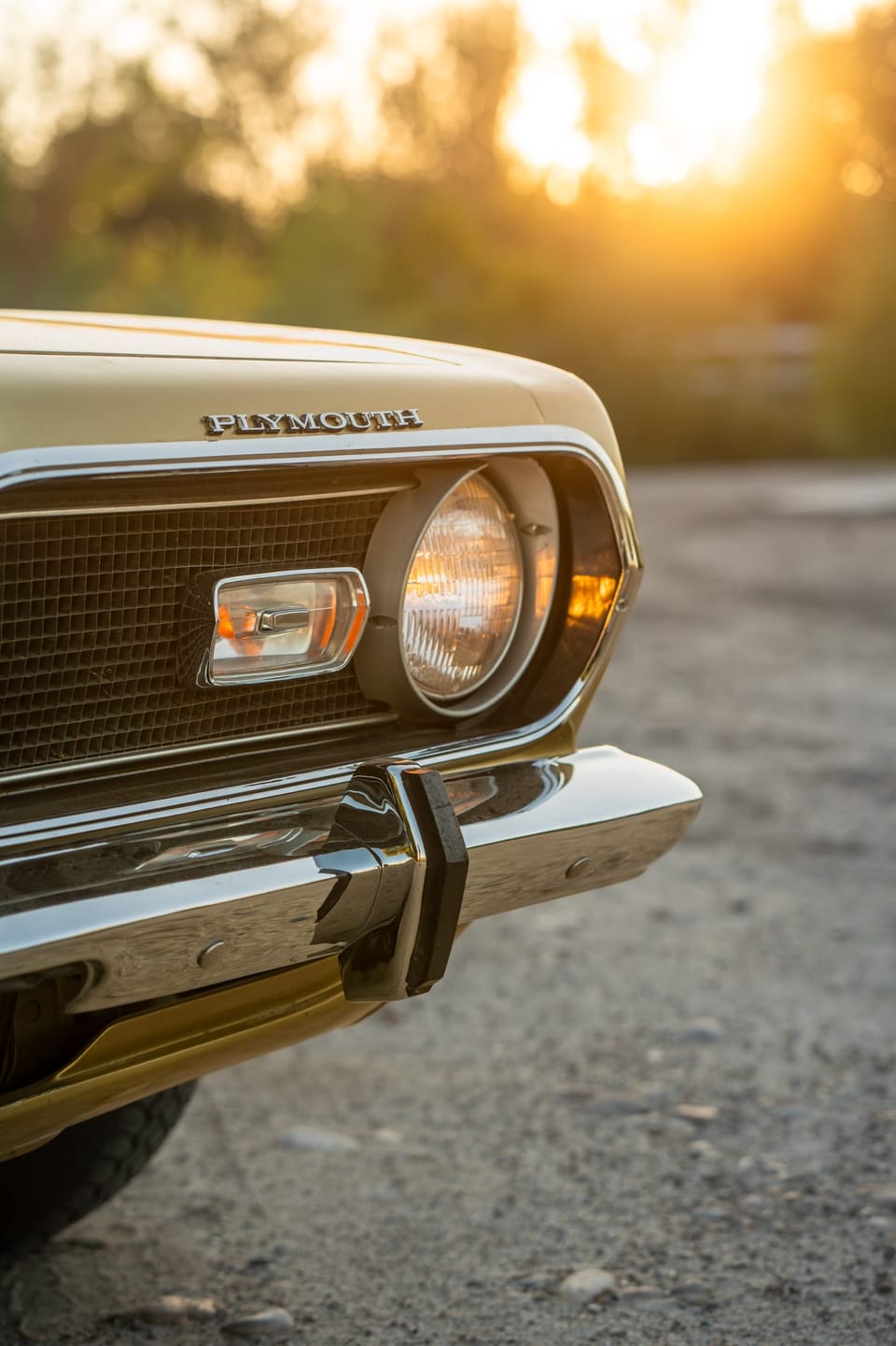 Headlight of a classic Barracuda with a warm sun flare
