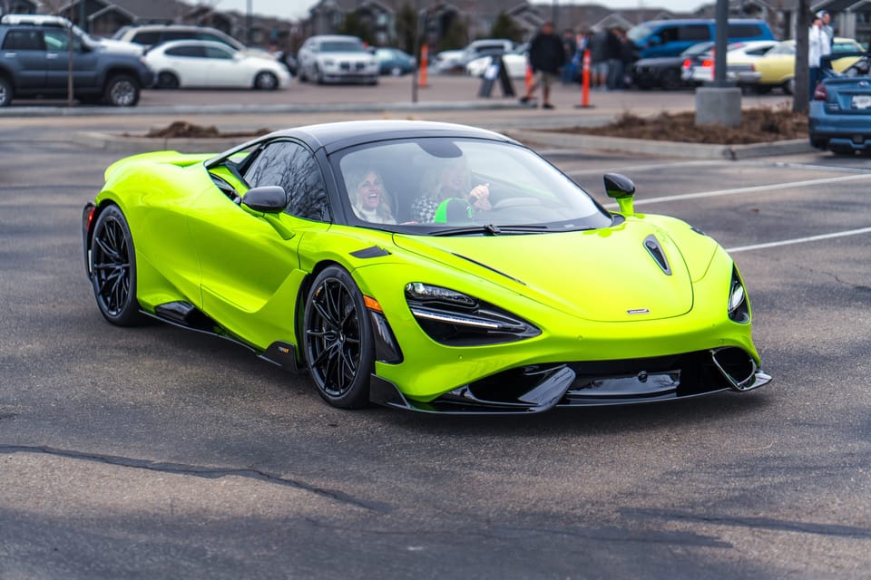 Lime-green McLaren parked in an open lot