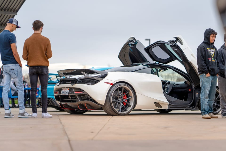 White McLaren with doors up at a cars and coffee meet