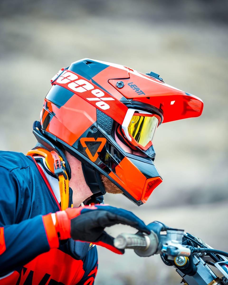 Motocross rider in an orange helmet and goggles