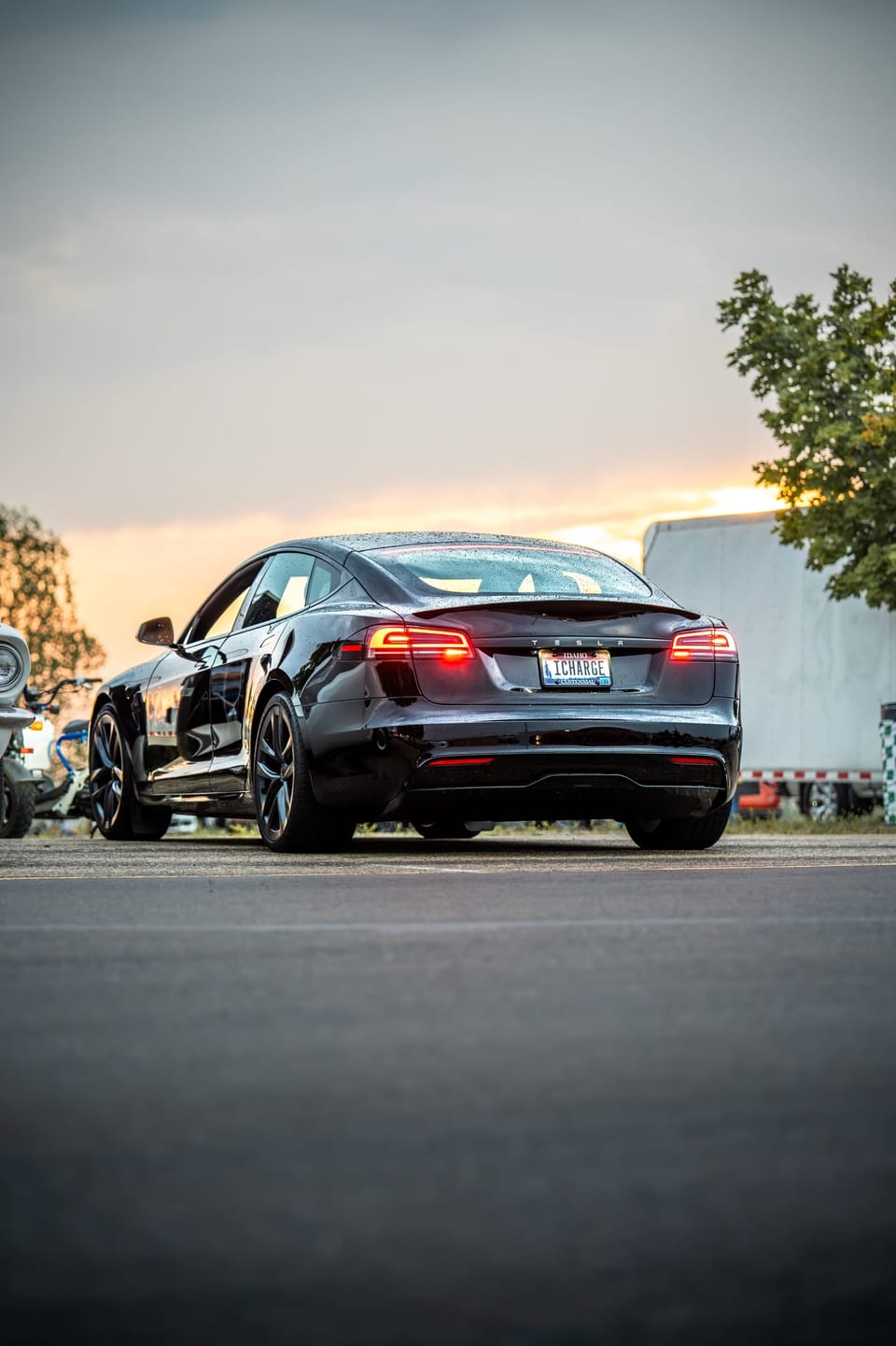 Dark sports sedan parked at dusk